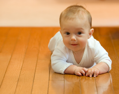 Baby crawling across lovely warm underfloor heated floor